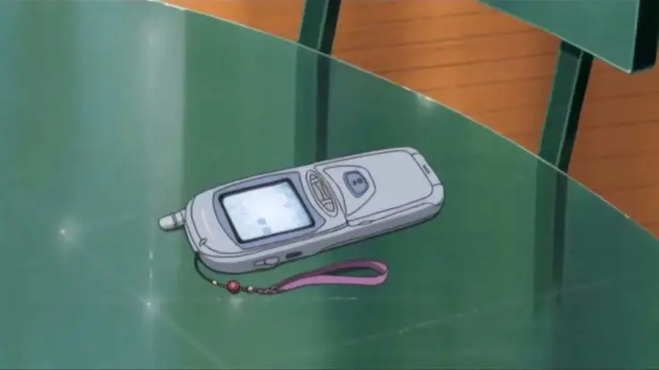 Menikmati Anime di Ponsel Gambar seseorang menonton anime di ponselnya